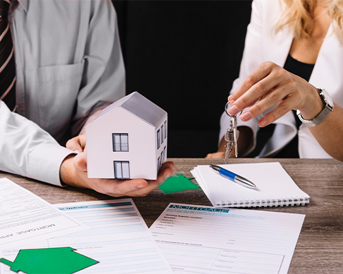 Real Estate Lawyer in Milton reviewing property documents with a client.